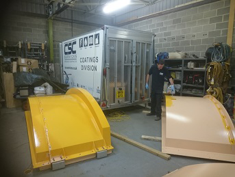 Application of marine grade coating top-coat to tank lids